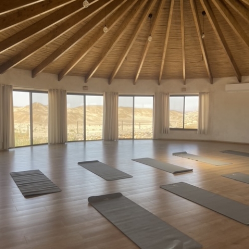 מזרנים בצבע אפור בתוך סטודיו מול נוף של הרים